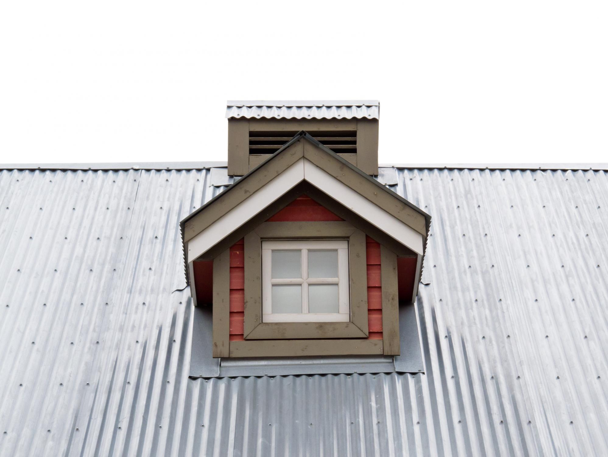 gray roof top with chimney and attic window